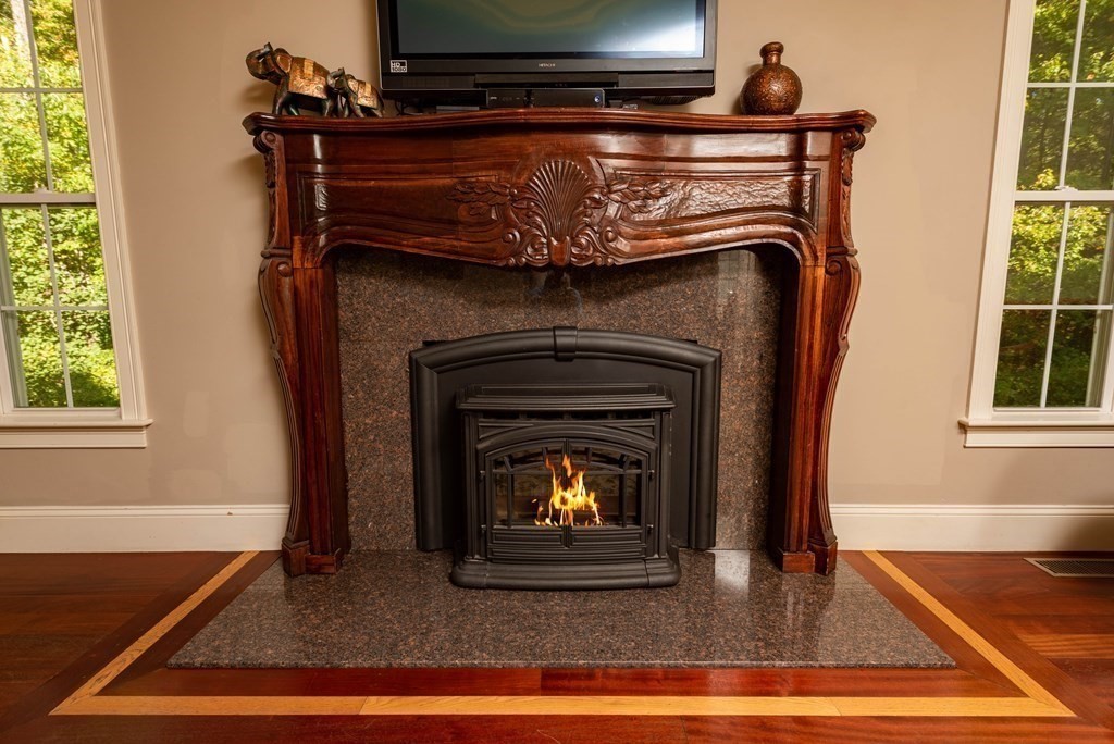 63 Bridge Street Raynham, MA 02767 - Photo 16 of 38 a living room with a fireplace and a fireplace