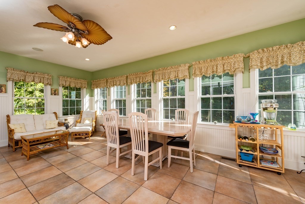 63 Bridge Street Raynham, MA 02767 - Photo 17 of 38 a dining room with furniture a chandelier and a rug
