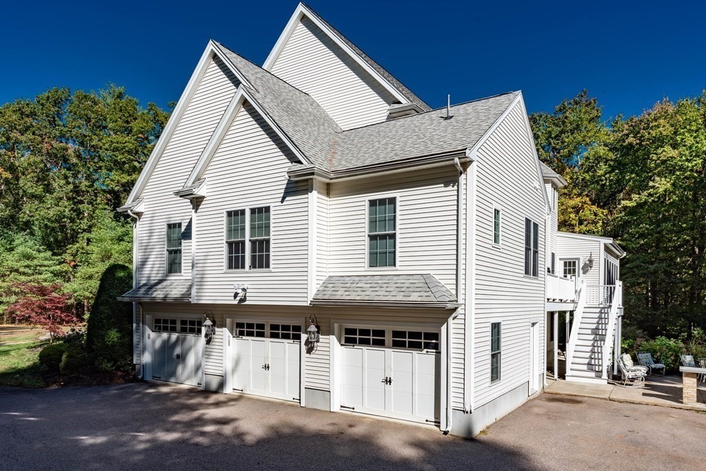 63 Bridge Street Raynham, MA 02767 - Photo 2 of 38 a view of a white house with a small yard and large tree