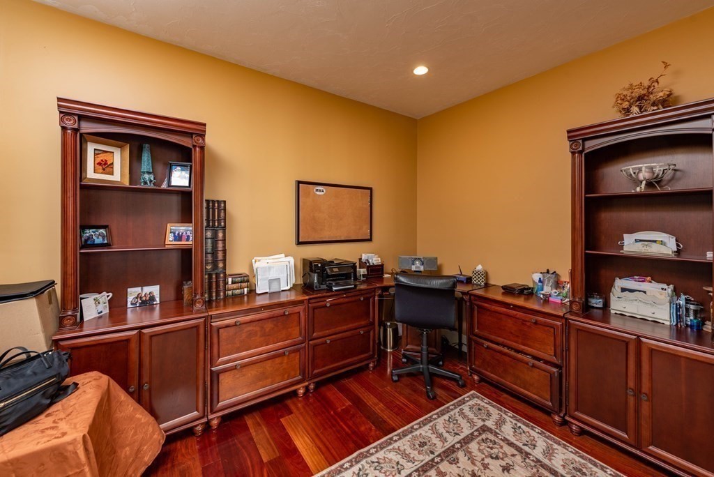 63 Bridge Street Raynham, MA 02767 - Photo 22 of 38 a room with a couch and a bookshelf