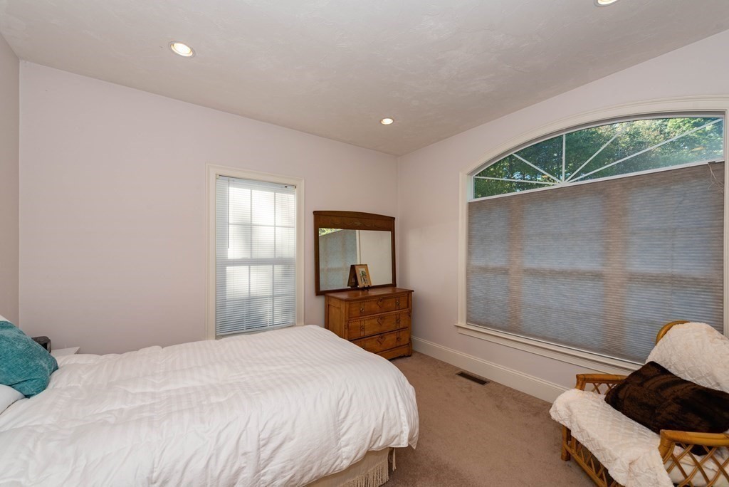 63 Bridge Street Raynham, MA 02767 - Photo 23 of 38 a bedroom with a bed and a window