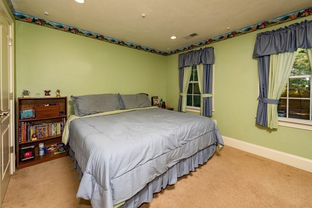 63 Bridge Street Raynham, MA 02767 - Photo 27 of 38 a bedroom with a bed and a closet