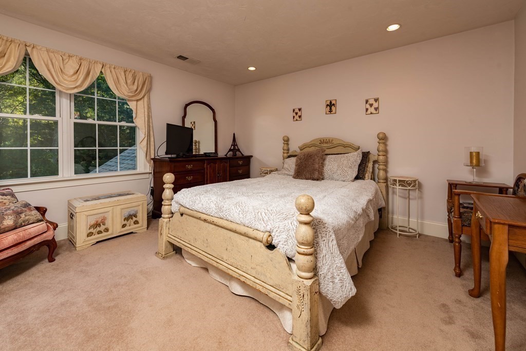 63 Bridge Street Raynham, MA 02767 - Photo 28 of 38 a bedroom with a bed and a window