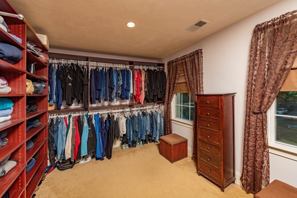 63 Bridge Street Raynham, MA 02767 - Photo 33 of 38 a view of walk in closet with clothes