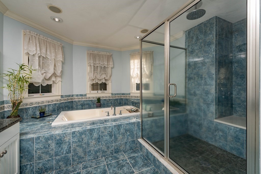 63 Bridge Street Raynham, MA 02767 - Photo 35 of 38 a bathroom with a bathtub and a shower