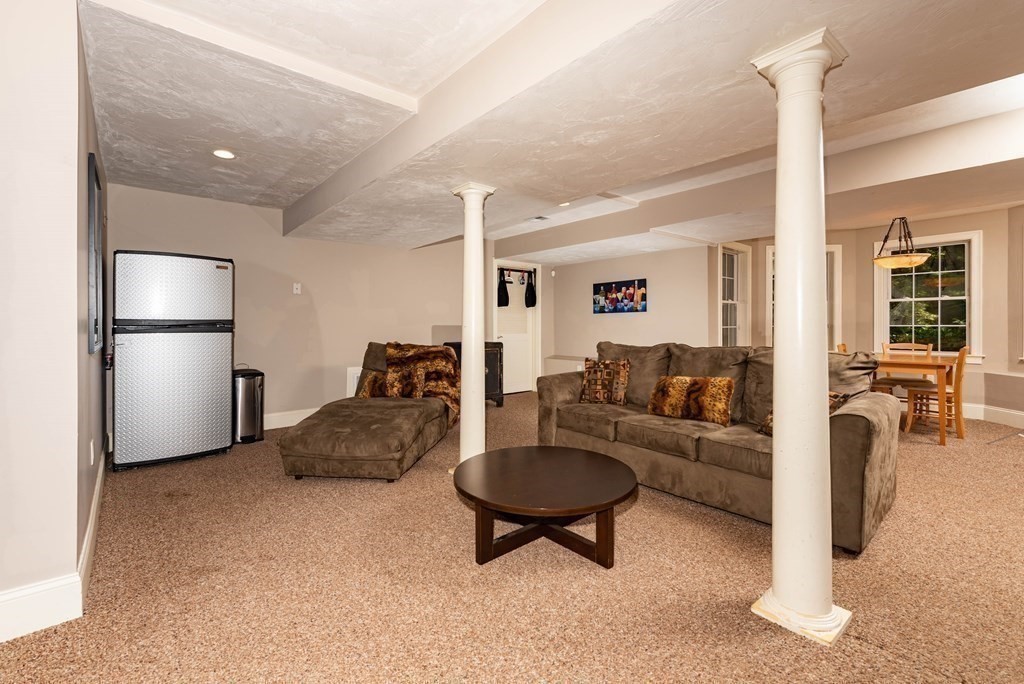 63 Bridge Street Raynham, MA 02767 - Photo 36 of 38 a living room with furniture and a refrigerator