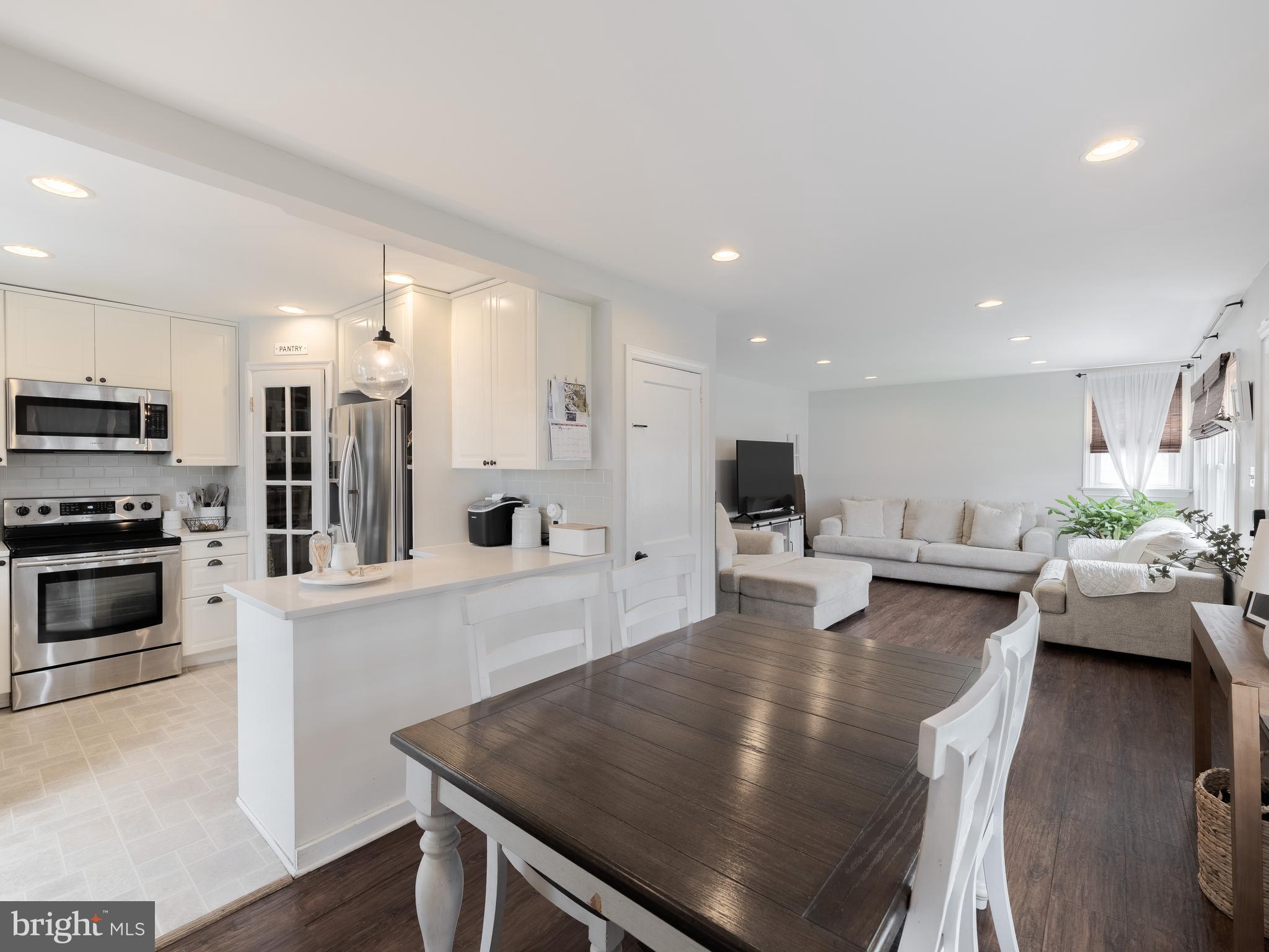 239 Hamel Avenue Glenside, PA 19038 - Photo 13 of 38 a kitchen with stainless steel appliances a table and chairs in it