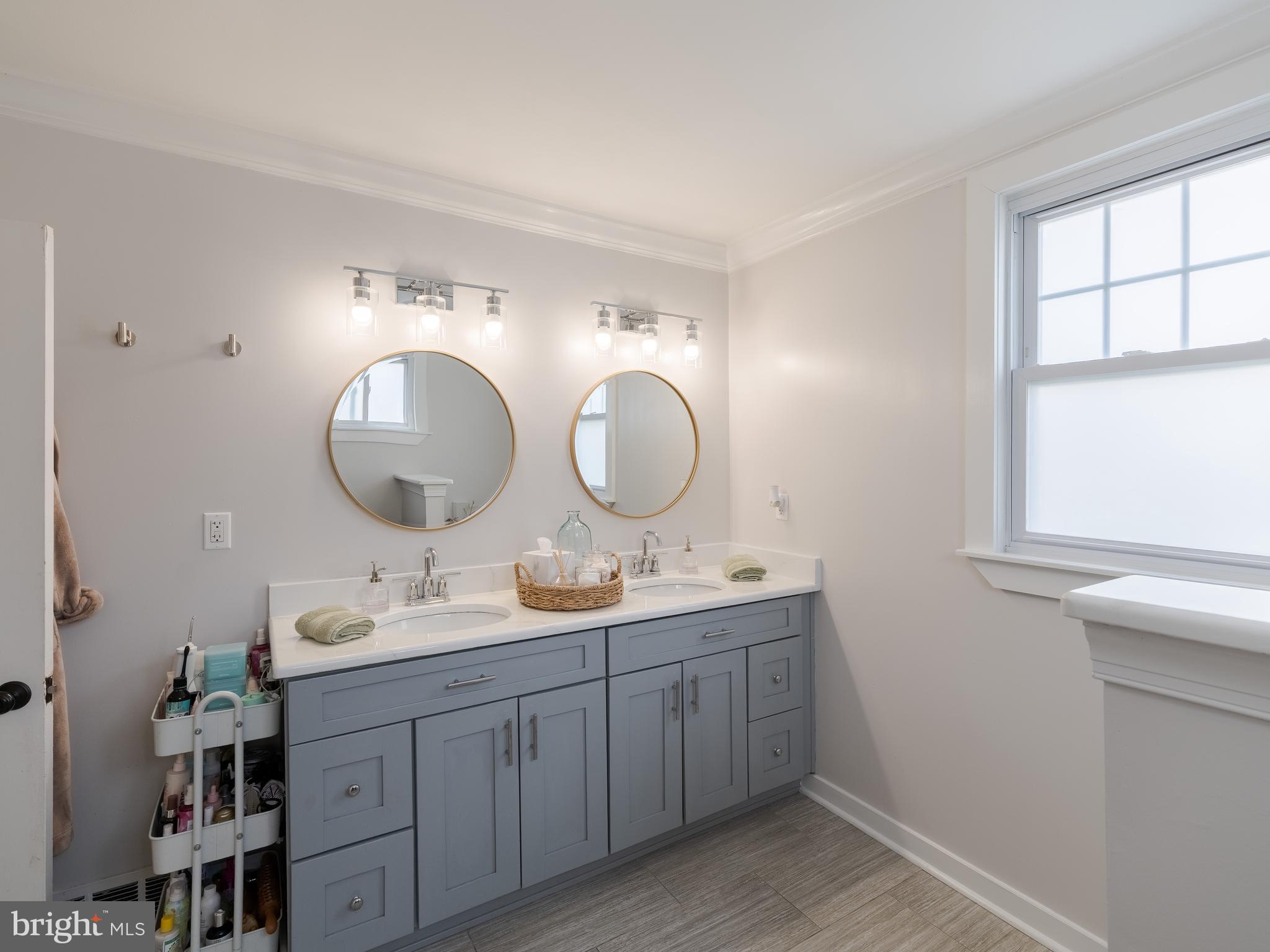 239 Hamel Avenue Glenside, PA 19038 - Photo 25 of 38 a bathroom with a double vanity sink and a mirror