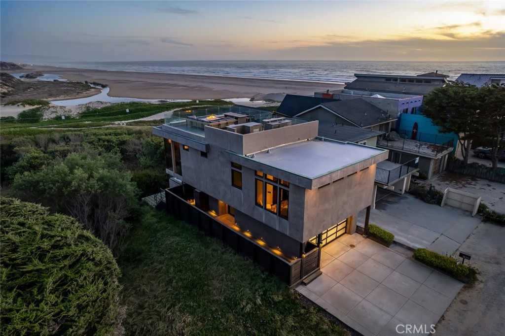 an aerial view of a house with garden space and ocean view