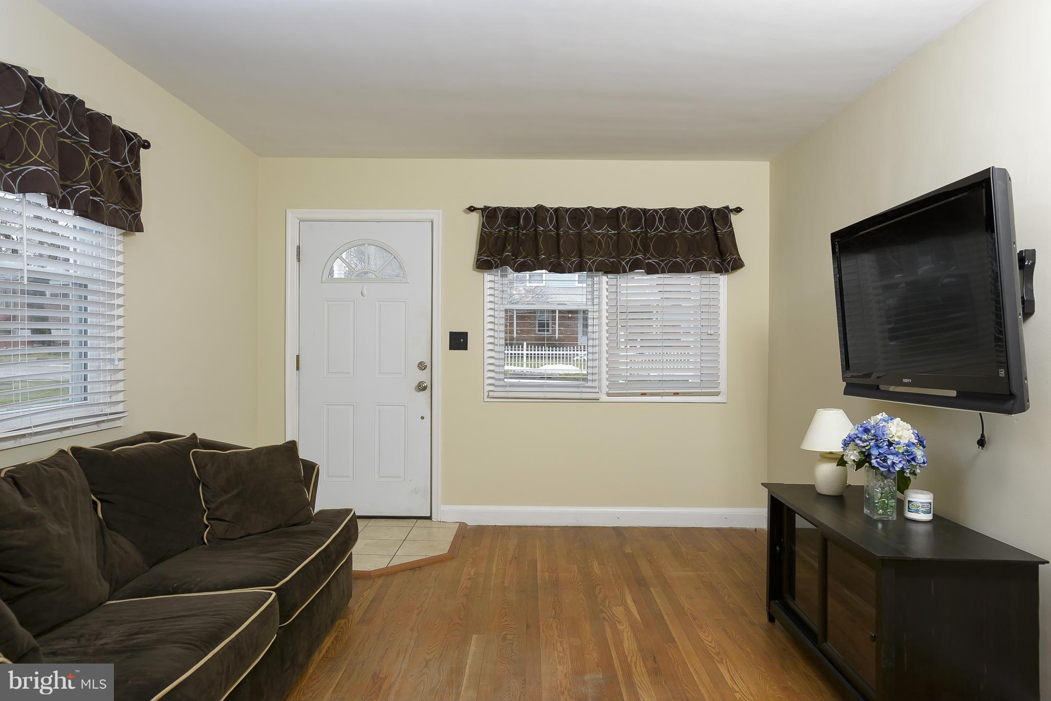 8107 Bon Air Road Baltimore, MD 21234 - Photo 6 of 30 a living room with furniture and a flat screen tv