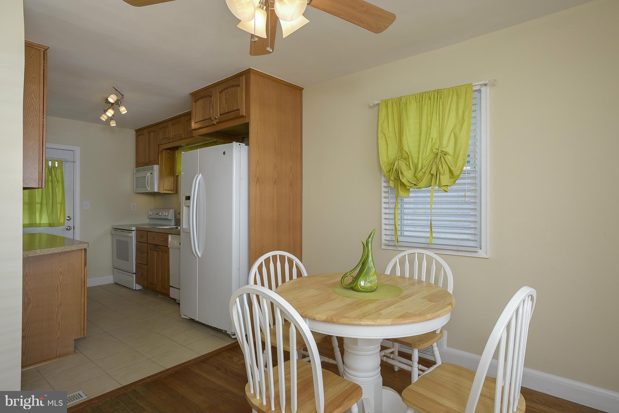 8107 Bon Air Road Baltimore, MD 21234 - Photo 7 of 30 a kitchen with stainless steel appliances granite countertop a dining table and chairs