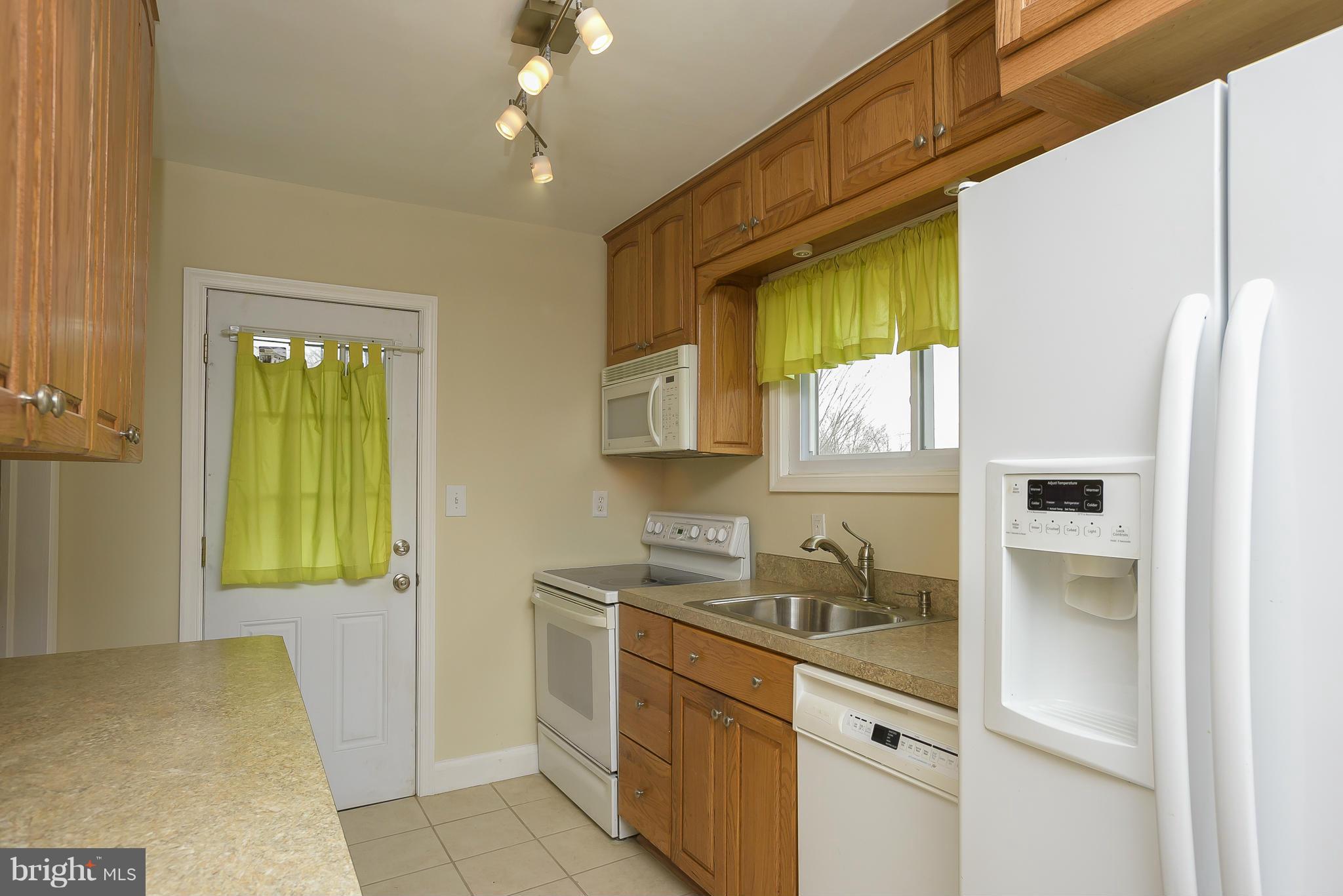 8107 Bon Air Road Baltimore, MD 21234 - Photo 8 of 30 a kitchen with a sink a refrigerator and window