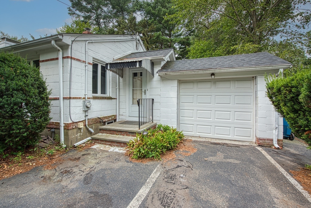 197 Turnpike Street Canton, MA 02021 - Photo 2 of 17 a view of a white house with large windows and a small yard