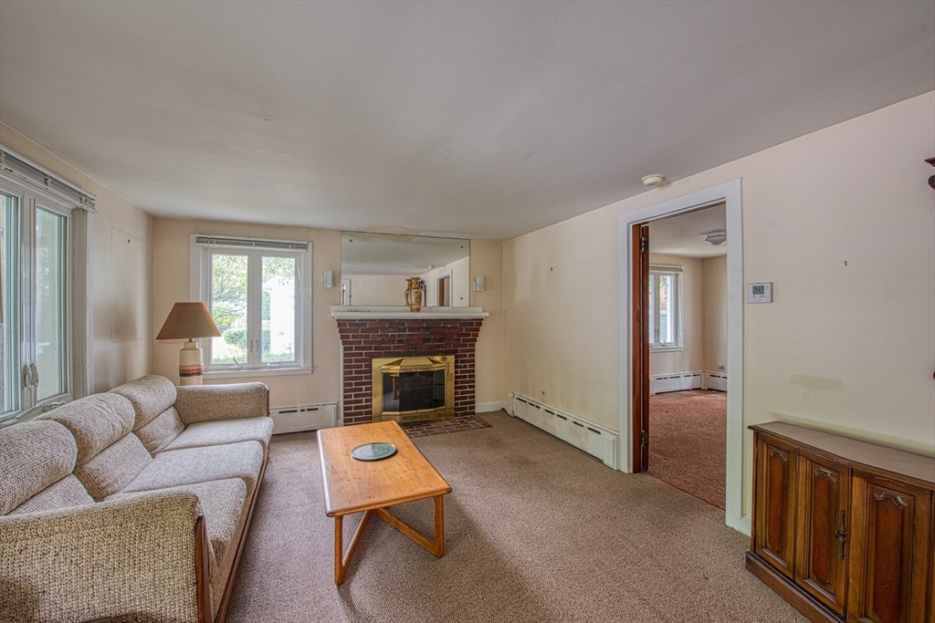 197 Turnpike Street Canton, MA 02021 - Photo 4 of 17 a living room with furniture and a fireplace