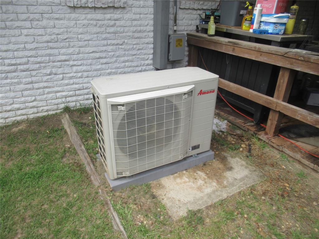 24133 Highway 157 Springhill, LA 71075 - Photo 10 of 19 Exterior HVAC unit on a concrete pad with a white brick facade