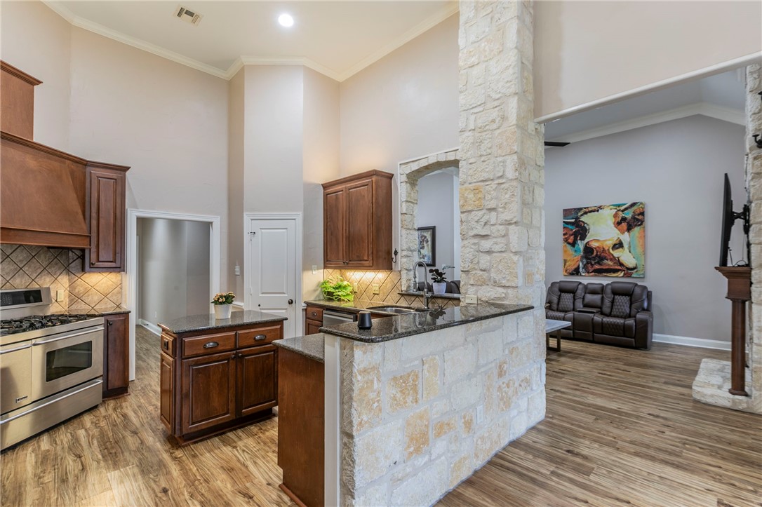 1031 Briar Glen Circle McGregor, TX 76657 - Photo 15 of 41 a kitchen with stainless steel appliances granite countertop a stove and a refrigerator
