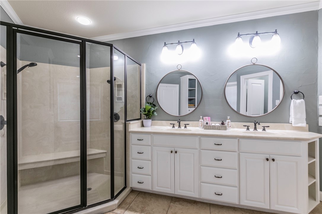 1031 Briar Glen Circle McGregor, TX 76657 - Photo 21 of 41 a bathroom with double vanity and a mirror