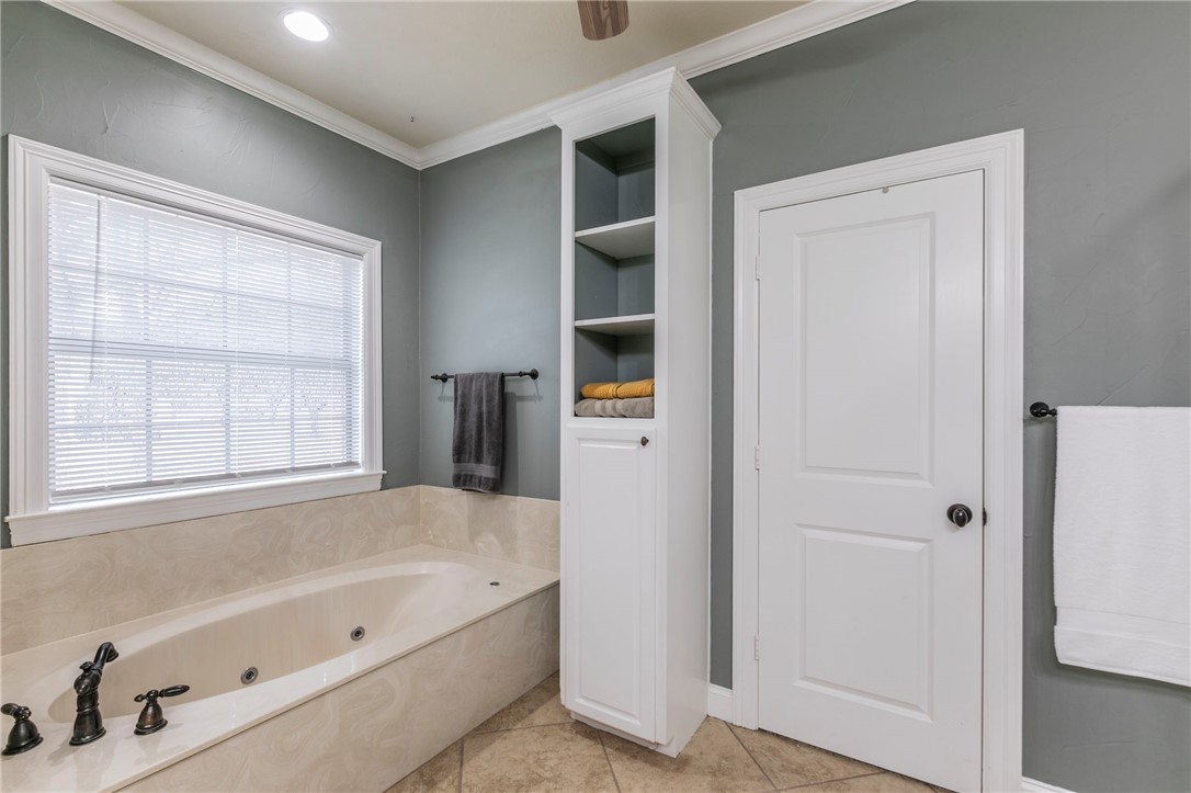 1031 Briar Glen Circle McGregor, TX 76657 - Photo 22 of 41 a bathroom with a tub a sink and a window