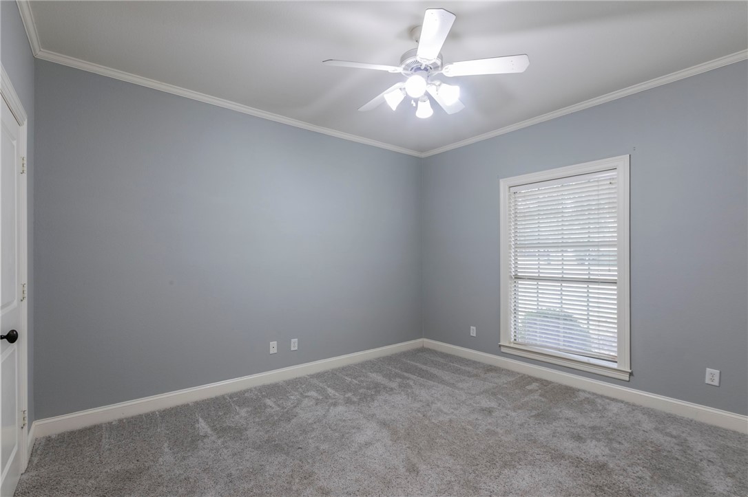 1031 Briar Glen Circle McGregor, TX 76657 - Photo 24 of 41 an empty room with a ceiling fan and window