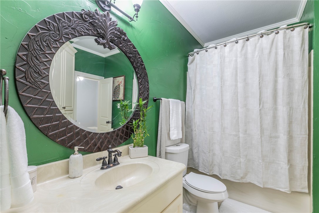 1031 Briar Glen Circle McGregor, TX 76657 - Photo 26 of 41 a bathroom with a sink mirror and toilet