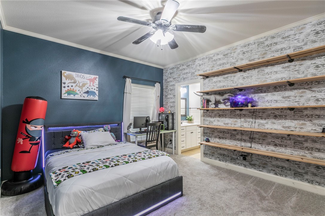 1031 Briar Glen Circle McGregor, TX 76657 - Photo 27 of 41 a bedroom with a bed and a chandelier