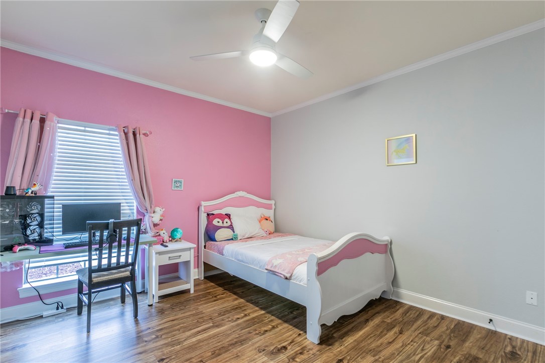 1031 Briar Glen Circle McGregor, TX 76657 - Photo 31 of 41 a bedroom with a bed and wooden floor