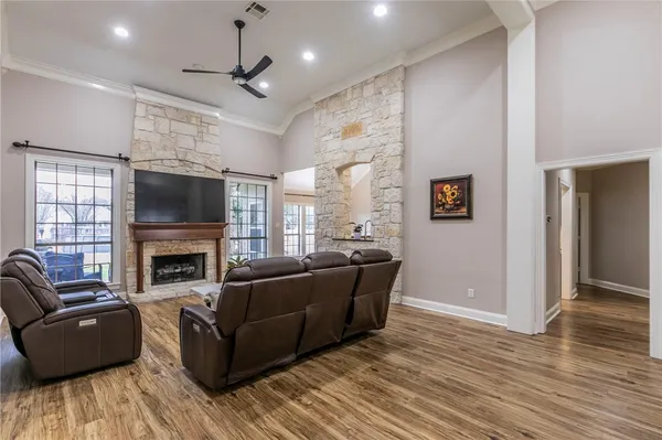 a living room with furniture a fireplace and a flat screen tv