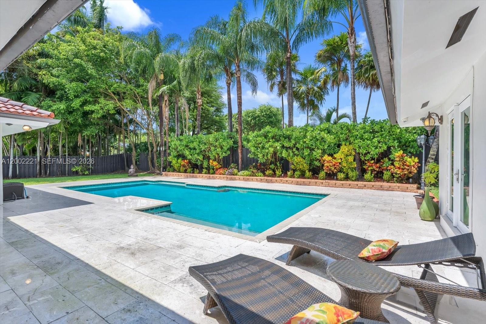 9941 Southwest 143rd Street Miami, FL 33176 - Photo 32 of 48 Extra large pool with manicured landscaping on one end of the pool deck