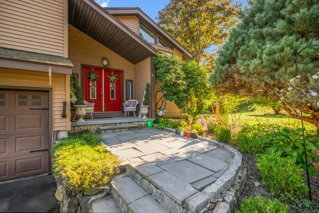 a front view of a house with garden