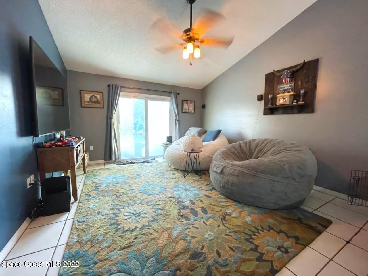 5125 Holden Road Cocoa, FL 32927 - Photo 4 of 6 a bedroom with furniture and a chandelier