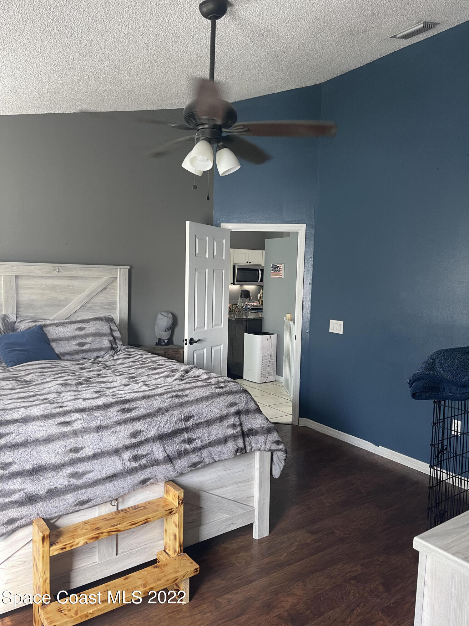 5125 Holden Road Cocoa, FL 32927 - Photo 6 of 6 a bedroom with a bed and wooden floor