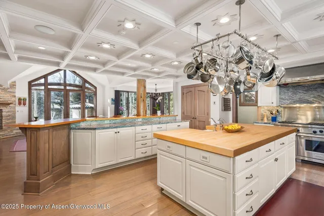 a living room with furniture a rug and a book shelf