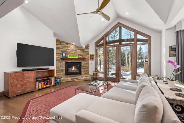 a bedroom with a large bed and a fireplace