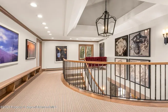 a bedroom with bed and a chandelier