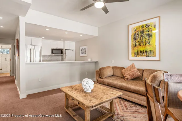 a view of a chair and table in backyard of the house