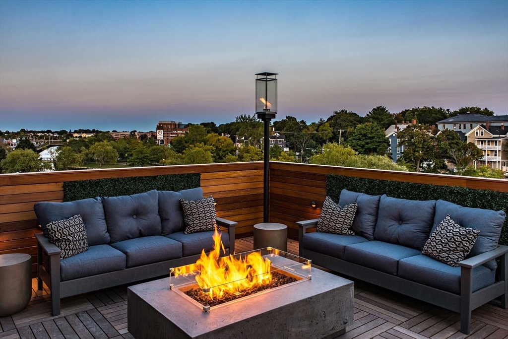 72 Flint, Unit 1307 Salem, MA 01970 - Photo 7 of 14 a view of a roof deck with couches and sky view