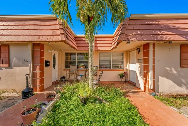 a view of a chair and tables in the patio