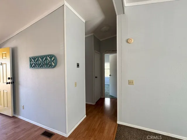 a view of a hallway with wooden floor