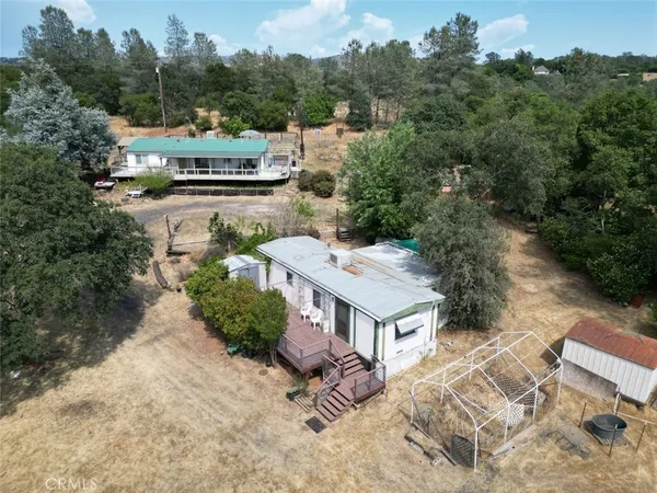 an aerial view of a house with a yard basket ball court and outdoor seating
