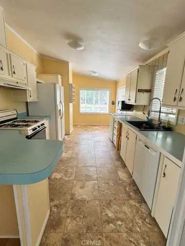a kitchen with stainless steel appliances granite countertop a sink and cabinets