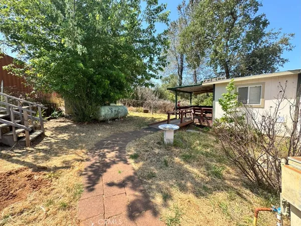 a view of a chair and table in backyard