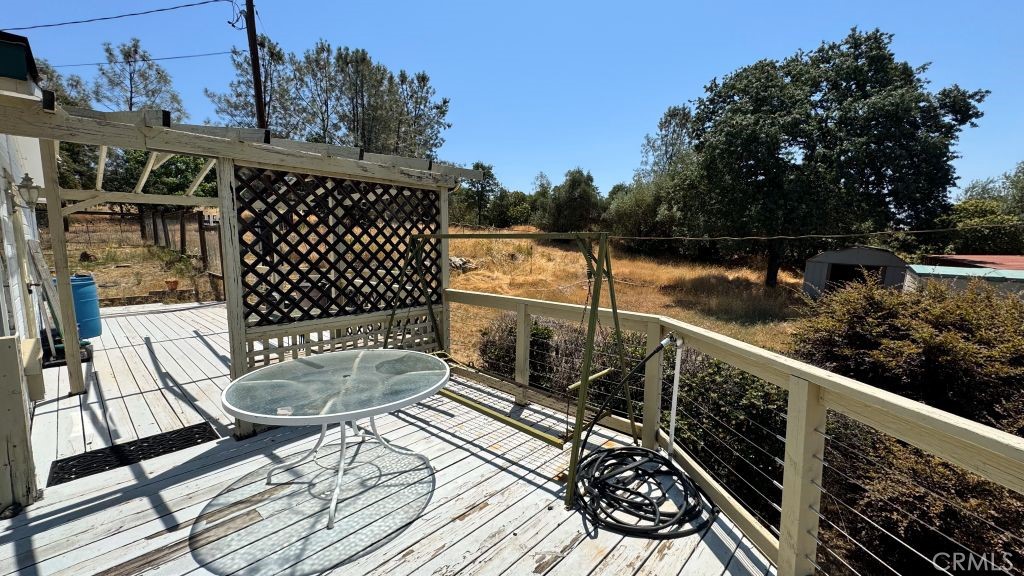 185 Grimont Road Oroville, CA 95966 - Photo 39 of 43 a balcony with wooden floor table and chairs