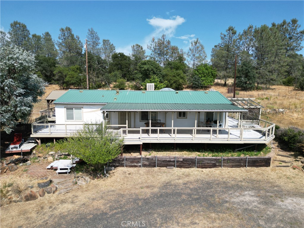 185 Grimont Road Oroville, CA 95966 - Photo 7 of 43 a front view of a house with a garden and swimming pool