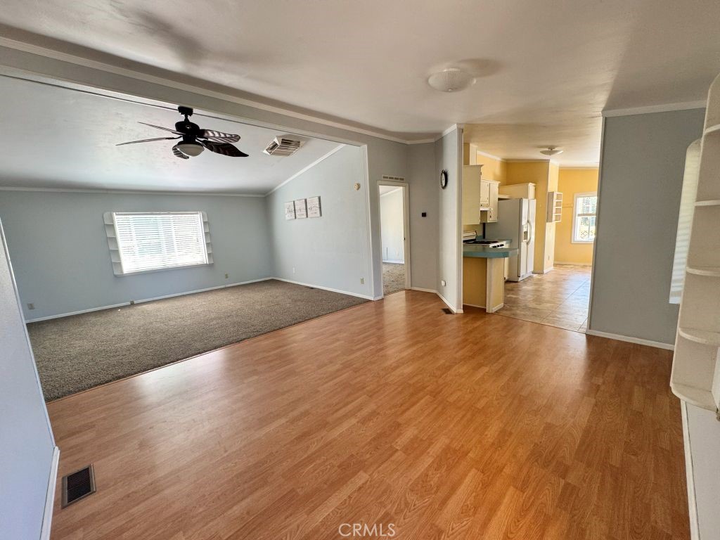 185 Grimont Road Oroville, CA 95966 - Photo 10 of 43 a view of a livingroom with wooden floor and a ceiling fan