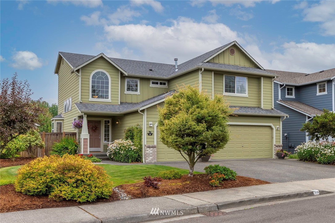 659 Shadow Avenue Northeast Renton, WA 98059 - Photo 2 of 37 a front view of a house with garden
