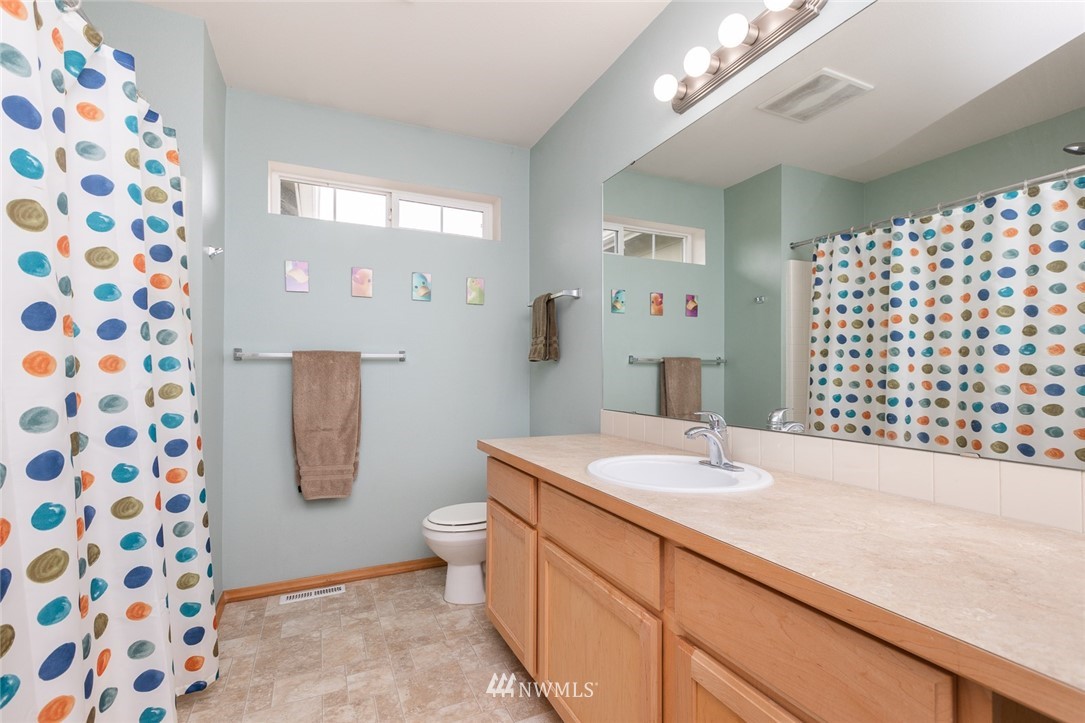 659 Shadow Avenue Northeast Renton, WA 98059 - Photo 26 of 37 a bathroom with a sink a toilet a shower and a mirror