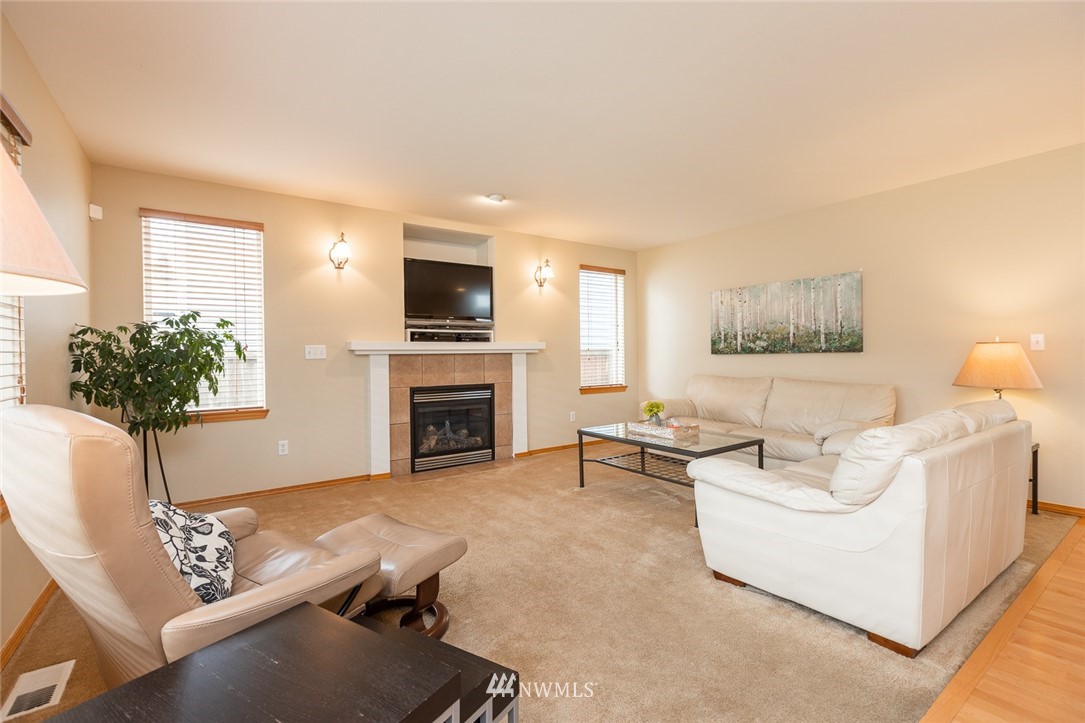 659 Shadow Avenue Northeast Renton, WA 98059 - Photo 10 of 37 a living room with furniture a fireplace and a potted plant