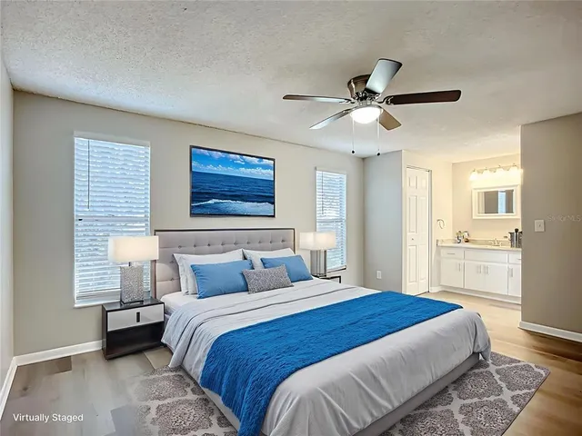 a bedroom with a large bed and a chandelier