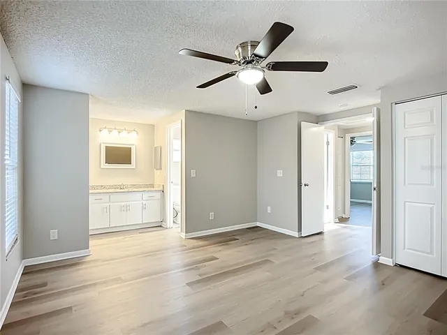 a view of an empty room and wooden floor