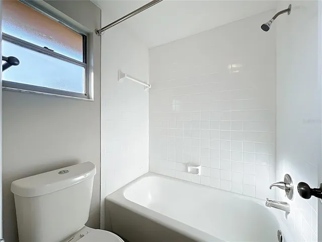 a bathroom with a bathtub and a toilet